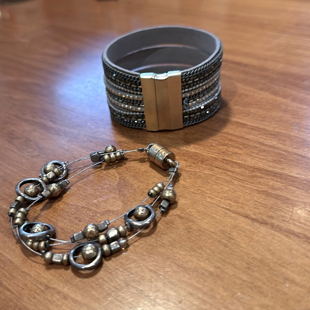 Two costume jewelry bracelets with magnetic closures.